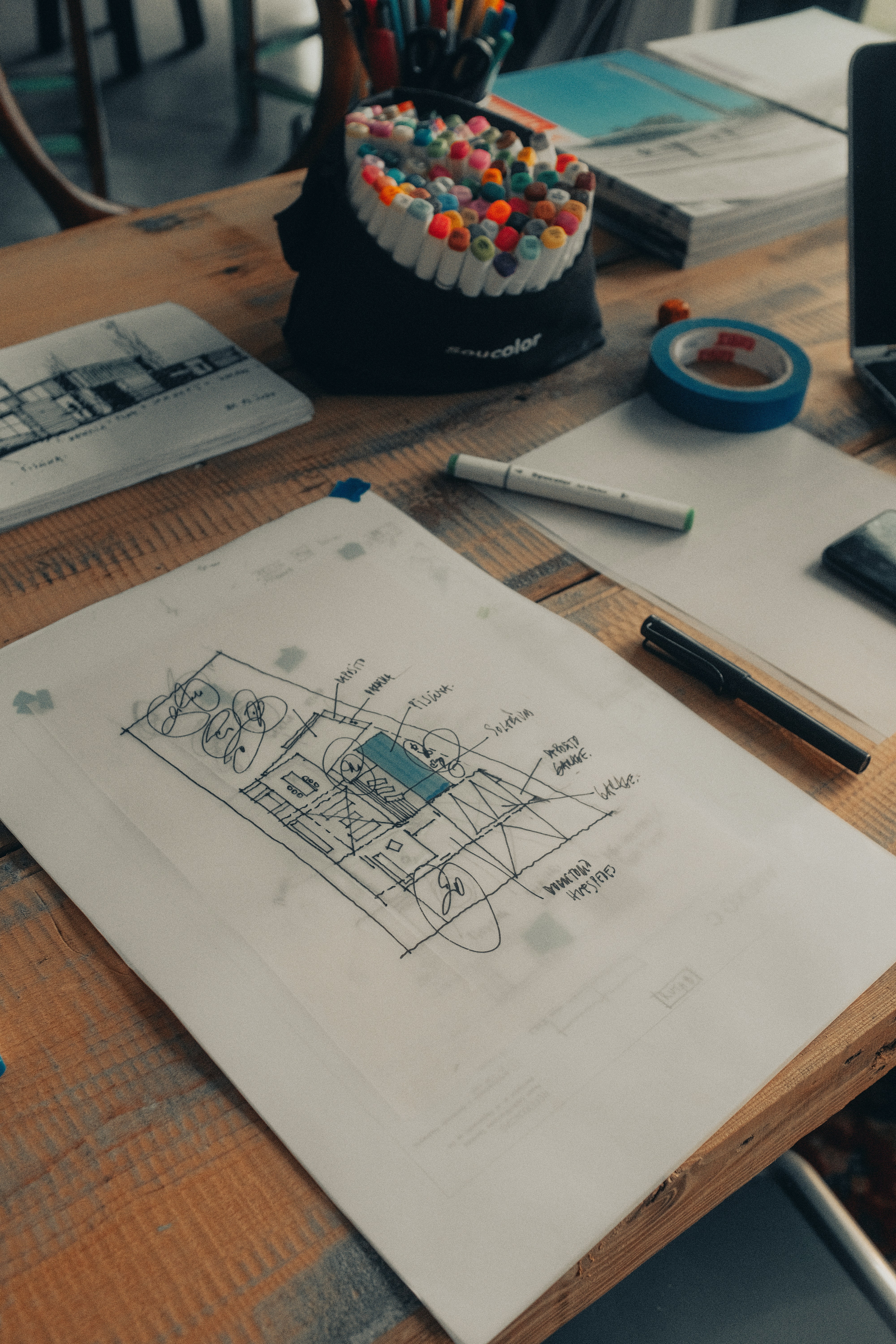 Marked-up construction sketch and planning materials on a work table