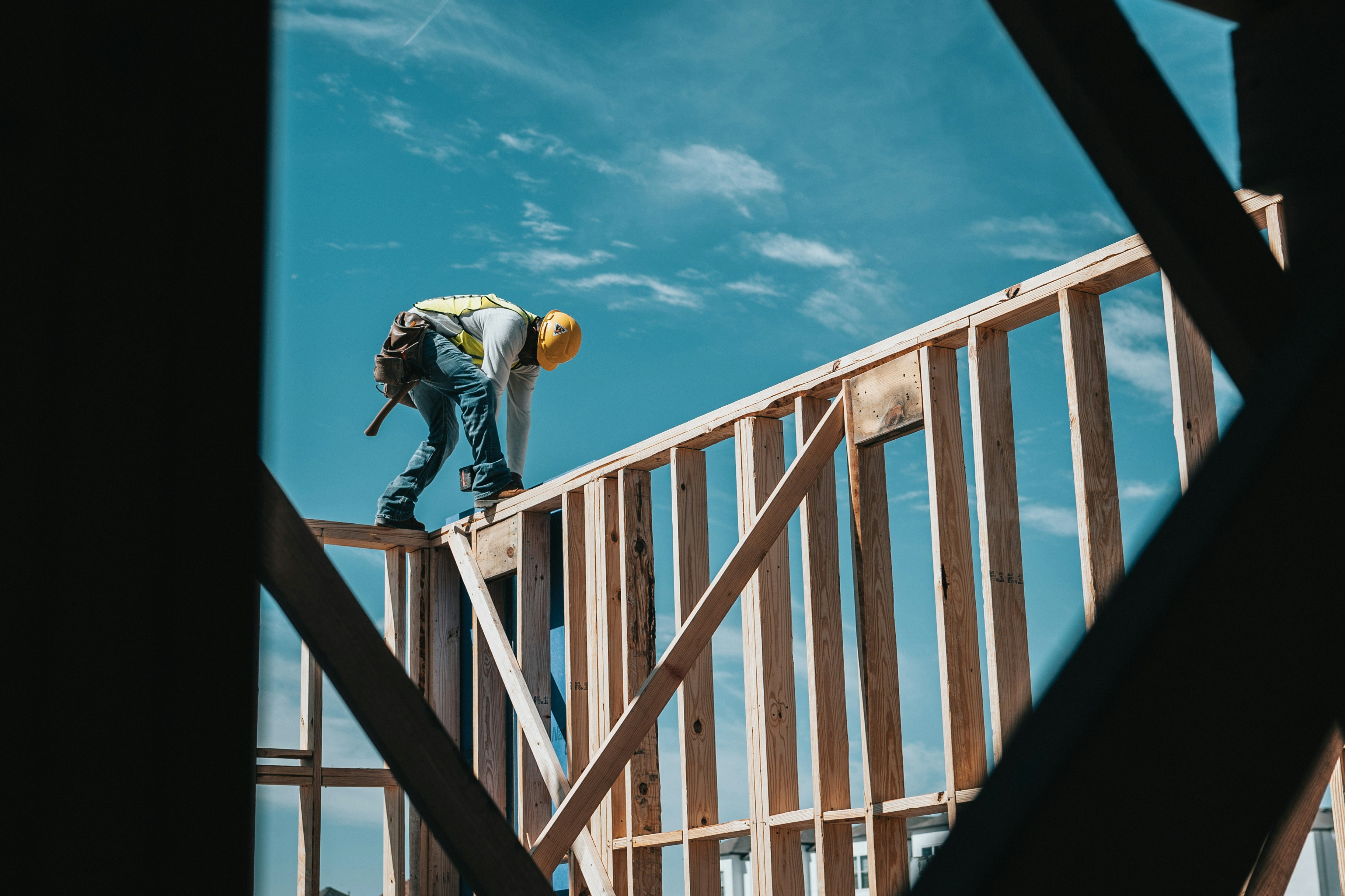 Worker installing wood framing on a construction site